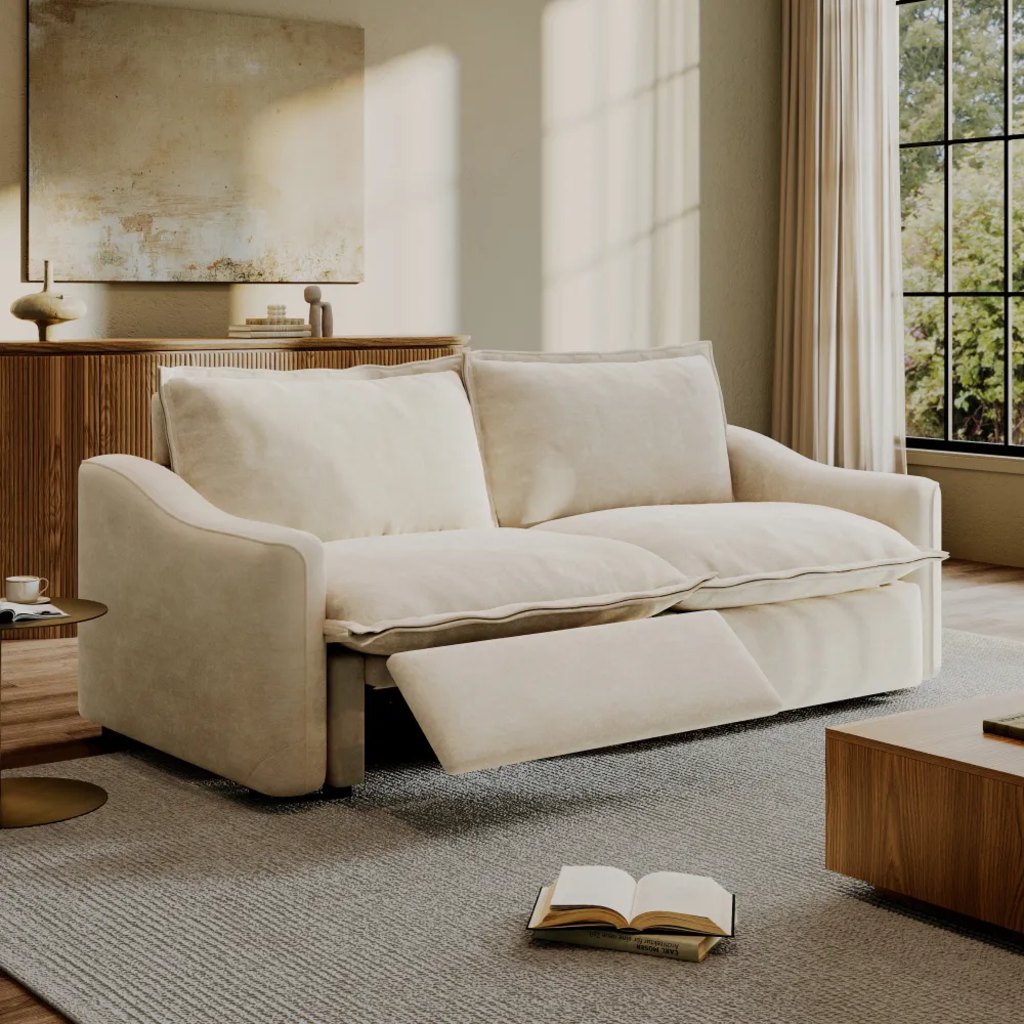 Cream power reclining loveseat with one footrest extended in a modern living room.