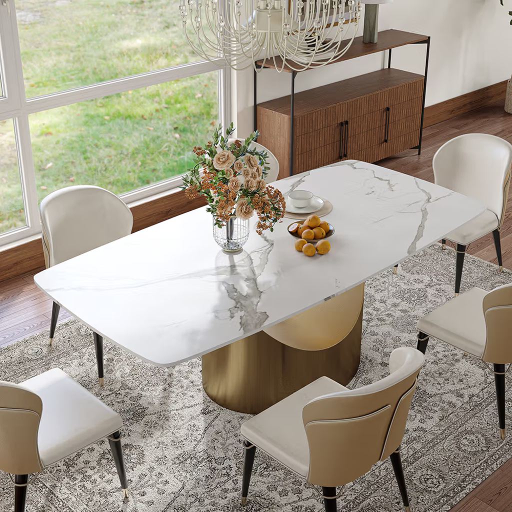 Rectangular sintered stone dining table with rounded corners and a central pedestal base in a modern dining room.