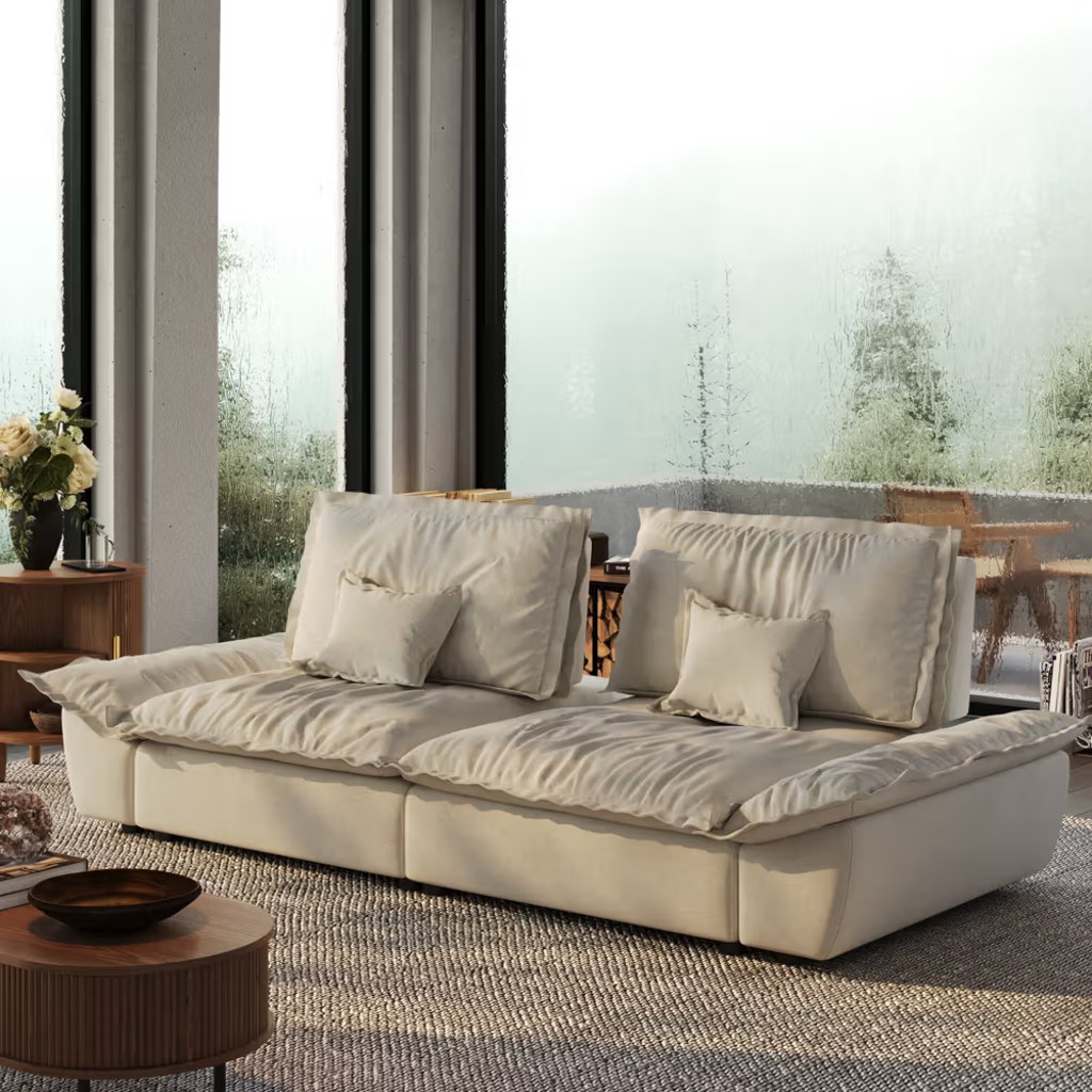 Cream deep-seat sofa with separate cushions and adjustable backrests in a bright shared apartment living room.