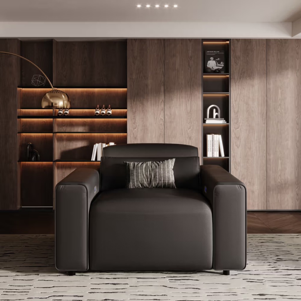 Dark brown leather recliner chair in a modern living room with built-in wood shelving.