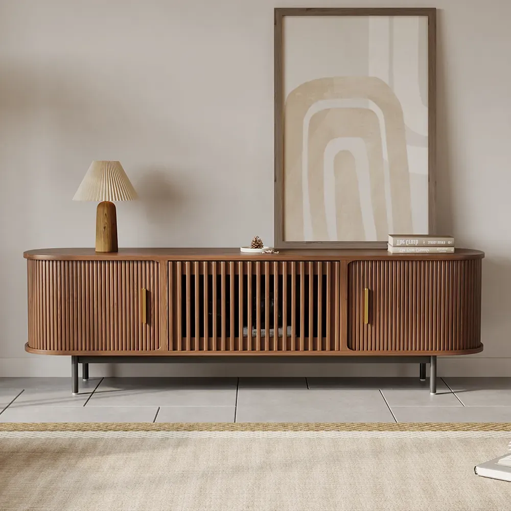 Walnut TV stand with curved slatted sliding doors and open center media storage in a neutral living room.