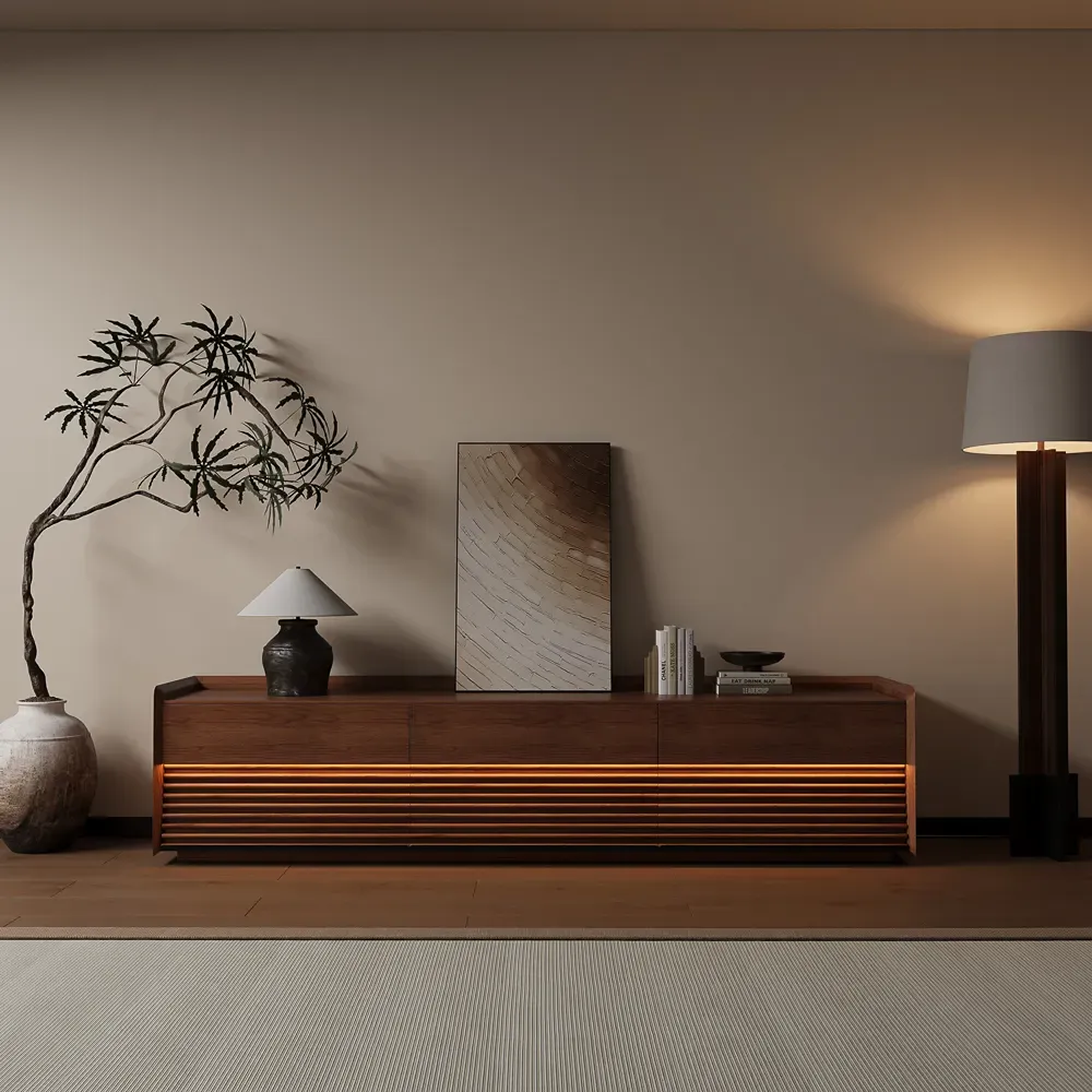Low-profile walnut media console with horizontal slatted doors in a modern living room.