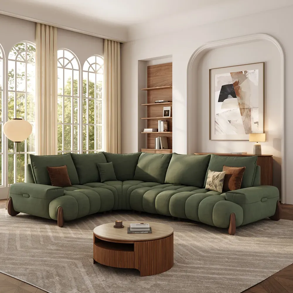 Green four-seat L-shaped sectional with deep cushions and a chaise in a warm modern family living room.