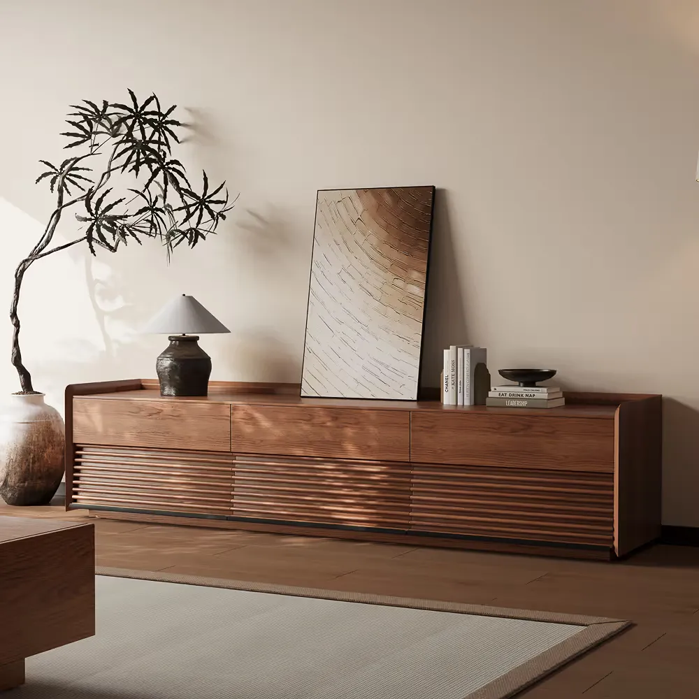 Mid-century modern wooden TV stand with slatted cabinet doors, decorative artwork, lamp, and minimalist living room styling.