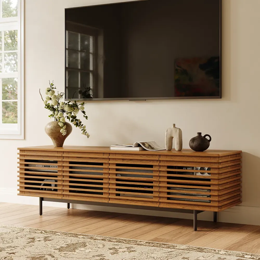Slatted wood TV stand with concealed audio equipment beneath a wall-mounted television.