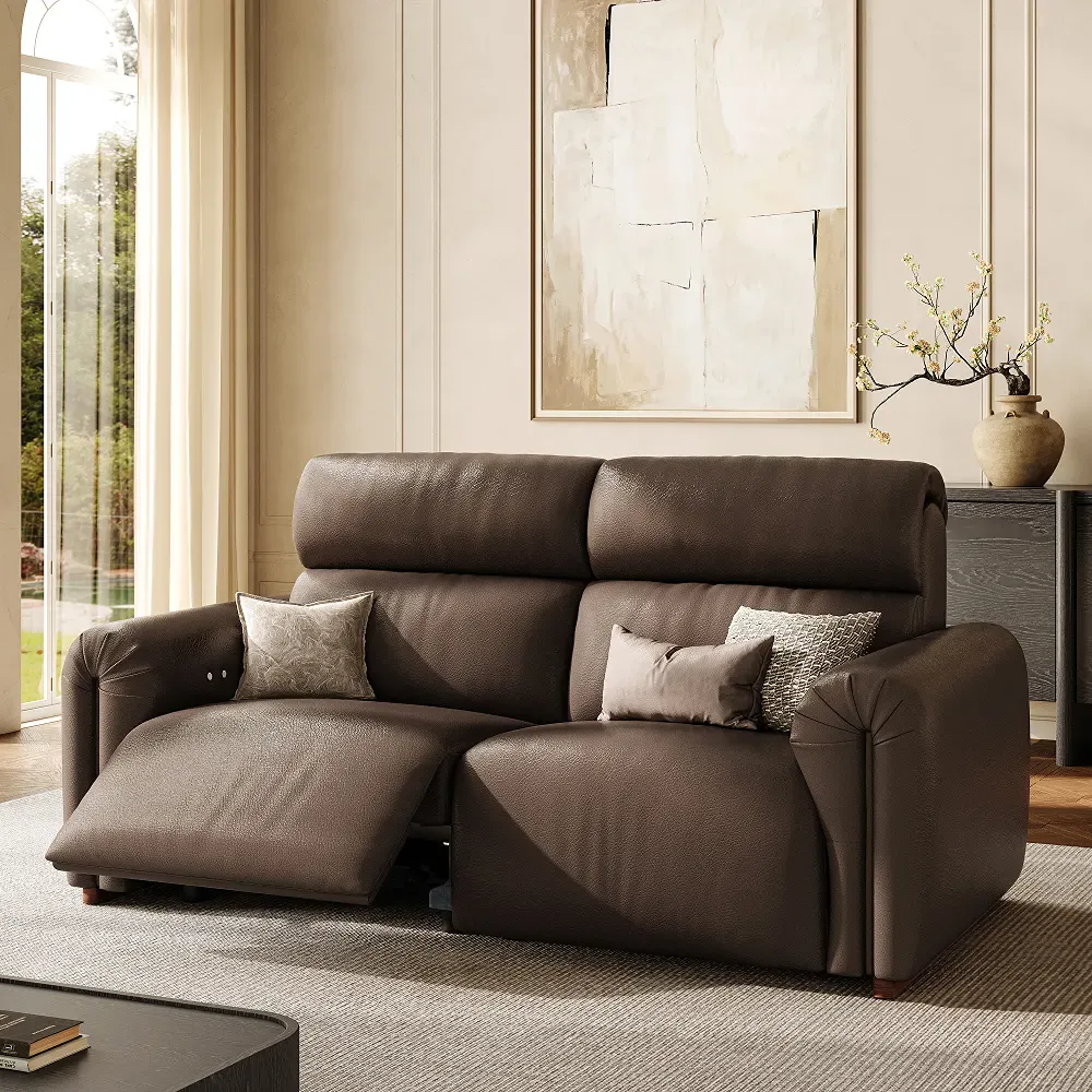 Brown high back power reclining loveseat with one footrest extended in a modern living room.