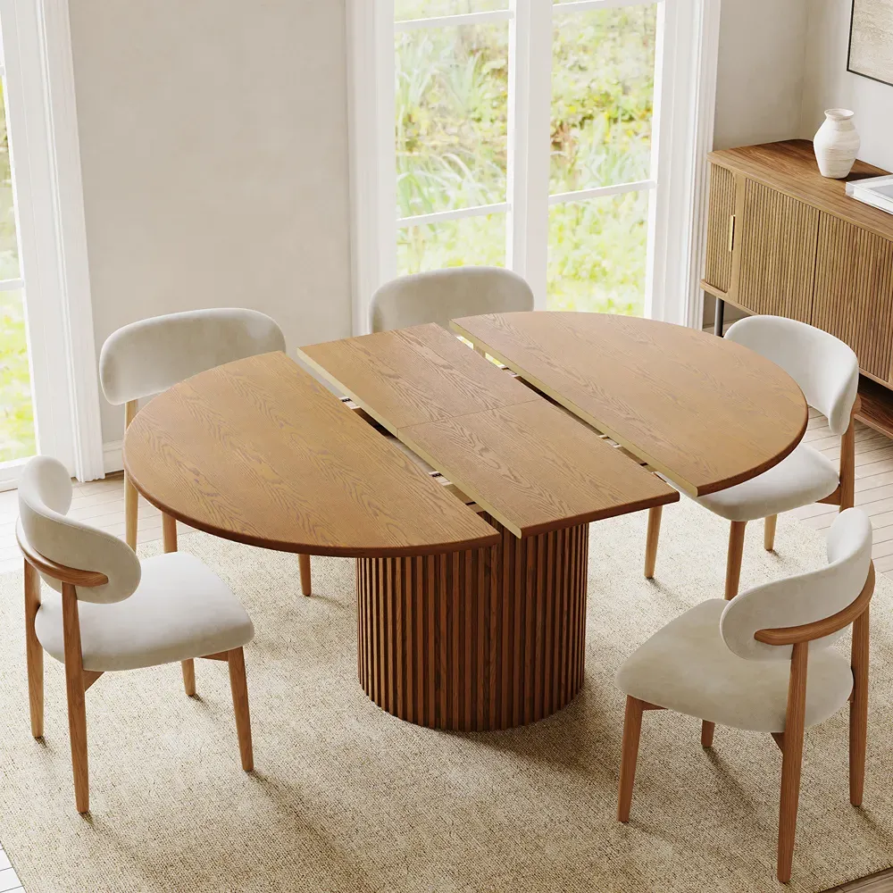 Extendable walnut dining table with six upholstered chairs in a bright dining room.