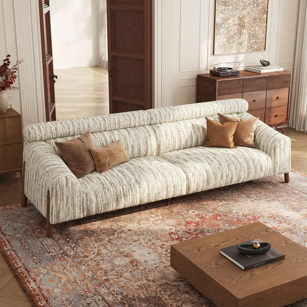 Large cream high back sofa with a dual-tier backrest in a spacious living room.