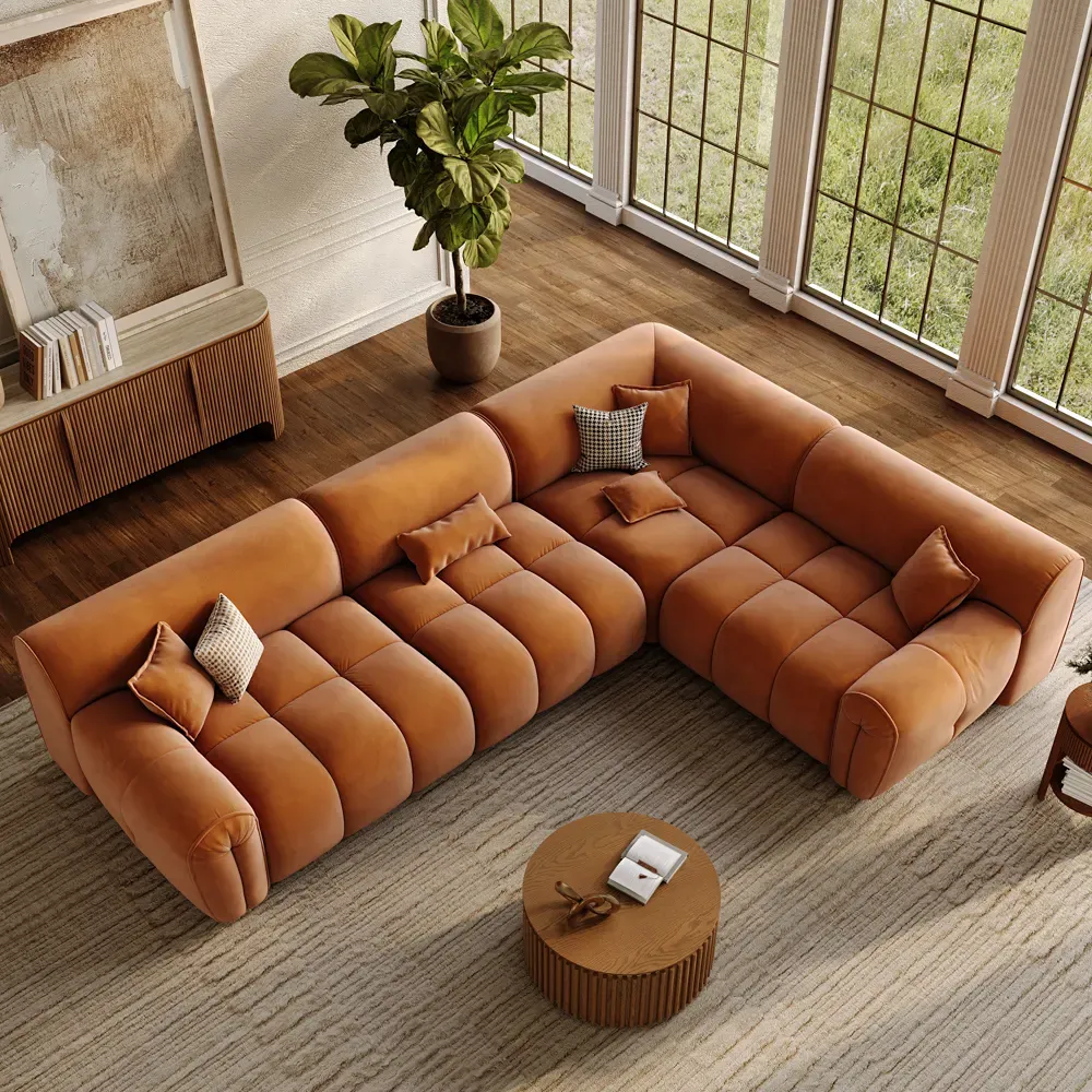 Top-down view of an orange L-shaped sectional arranged for shared family seating in a spacious open living room.