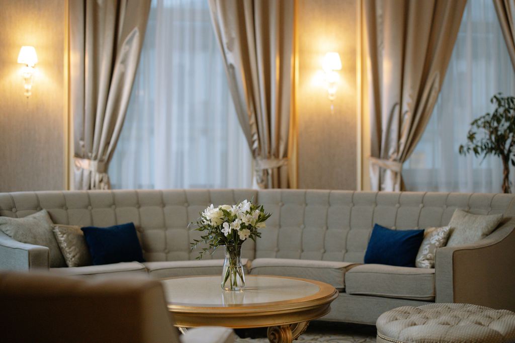 Curved gray sofa paired with a round coffee table in an elegant living room.