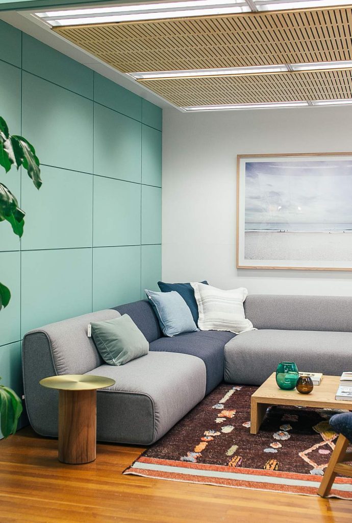 Gray modular sectional sofa on a patterned area rug in a modern living room