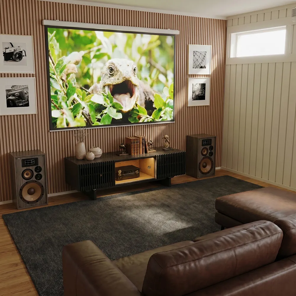 Dark media console with slatted doors for airflow and concealed cable management in a home theater setup with speakers and AV equipment