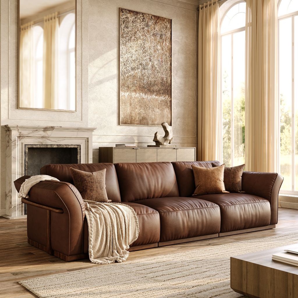 Modern Victorian living room with a brown leather sofa, arched windows, marble fireplace, wall molding, and warm neutral decor.