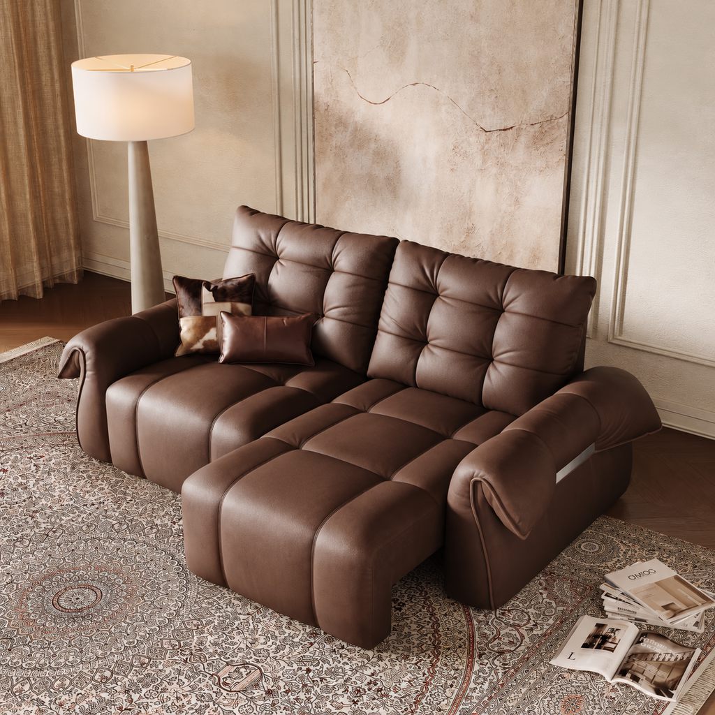 Dark brown leather sectional sofa in a warm living room with dark wood flooring and a patterned area rug