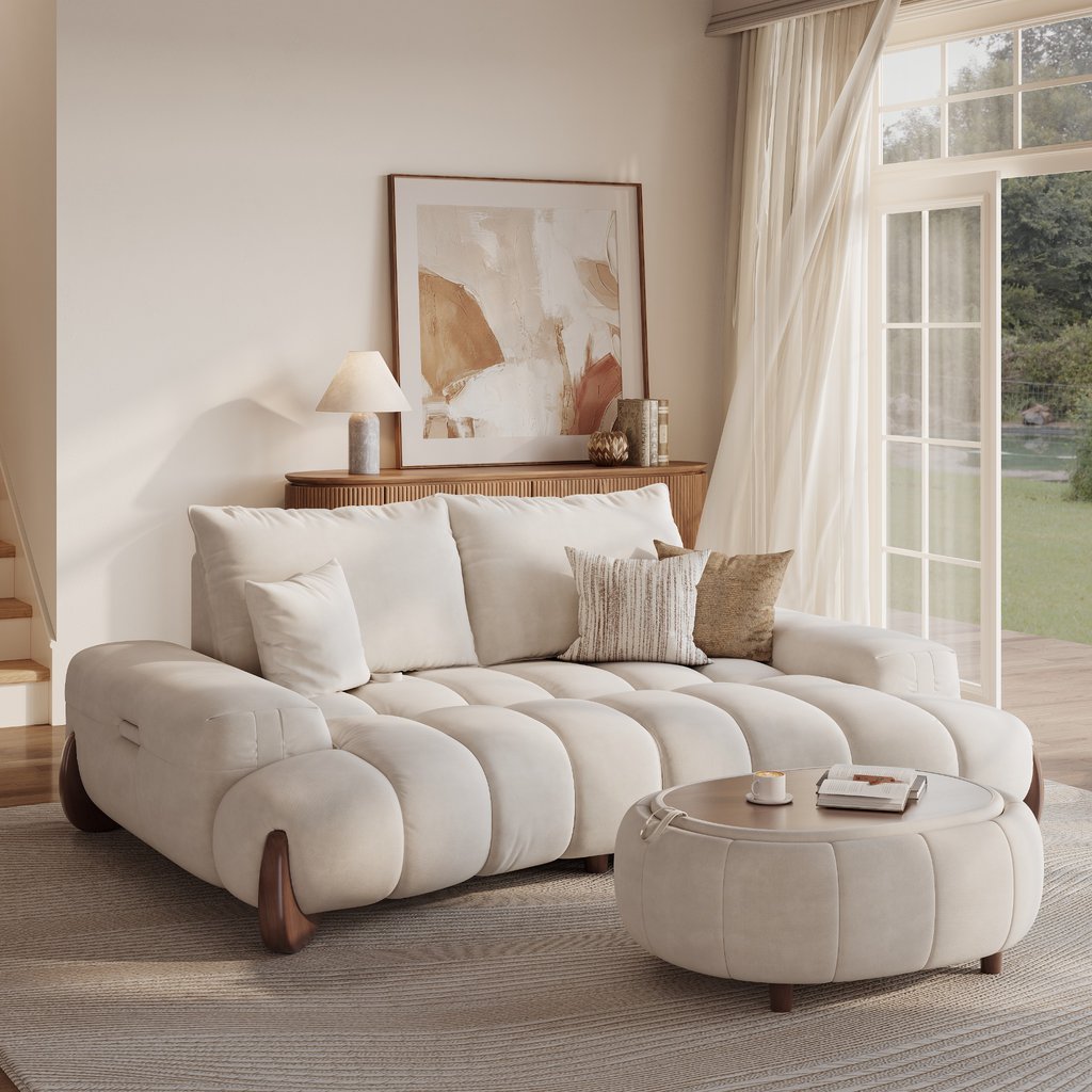 Cream modern Mediterranean living room with a curved sectional sofa, round coffee table, warm wood console, neutral rug, and soft natural light.