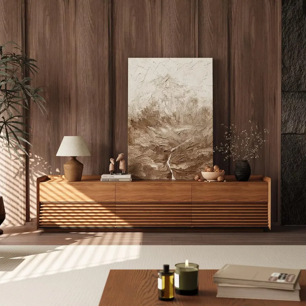 Warm Wabi Sabi living room with a low walnut media console, textured wall art, ceramic decor, and soft natural light.
