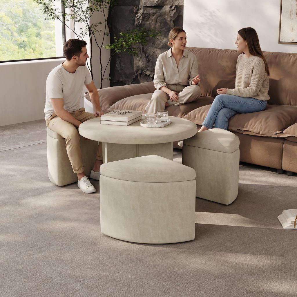 Three adults sitting around a coffee table beside a brown sectional sofa in a modern living room.