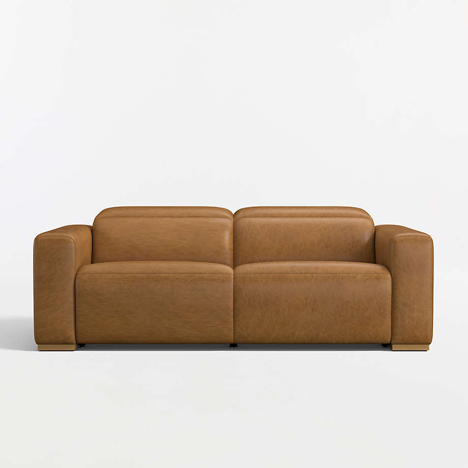 Brown leather two-seat reclining sofa with wide square arms on a white background