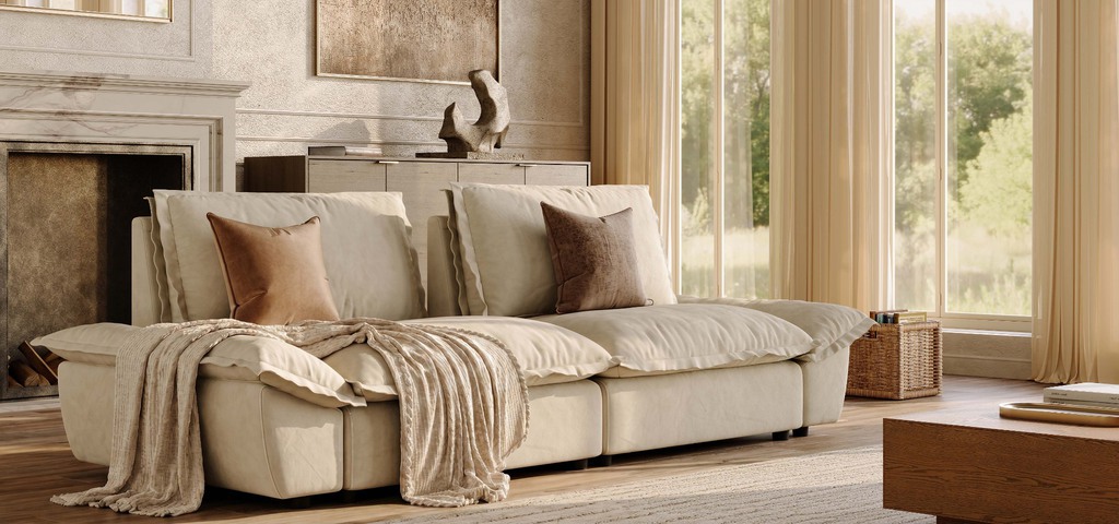 Cream modular sofa with deep cushions in a sunlit living room with large windows and a fireplace.