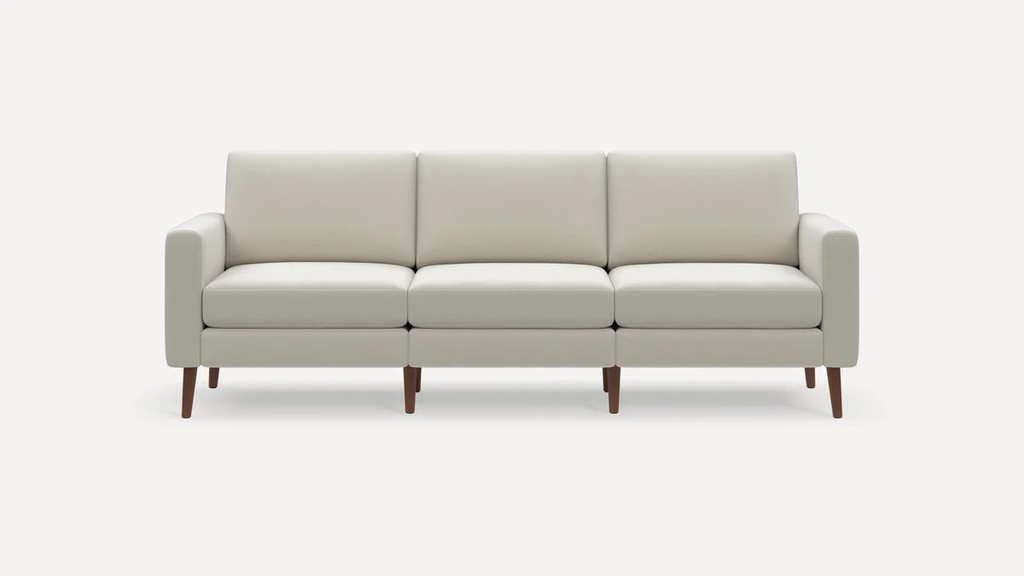 White high-arm three-seat sofa with clean lines and tapered wooden legs on a plain background.