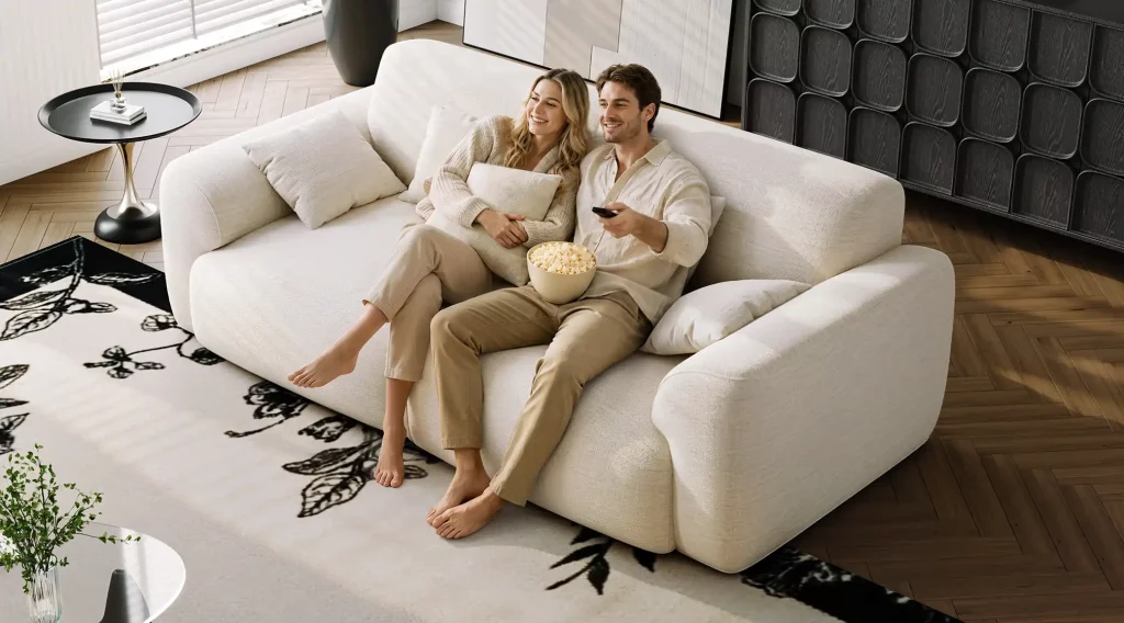 Couple sitting together on a white sofa bed in a modern living room