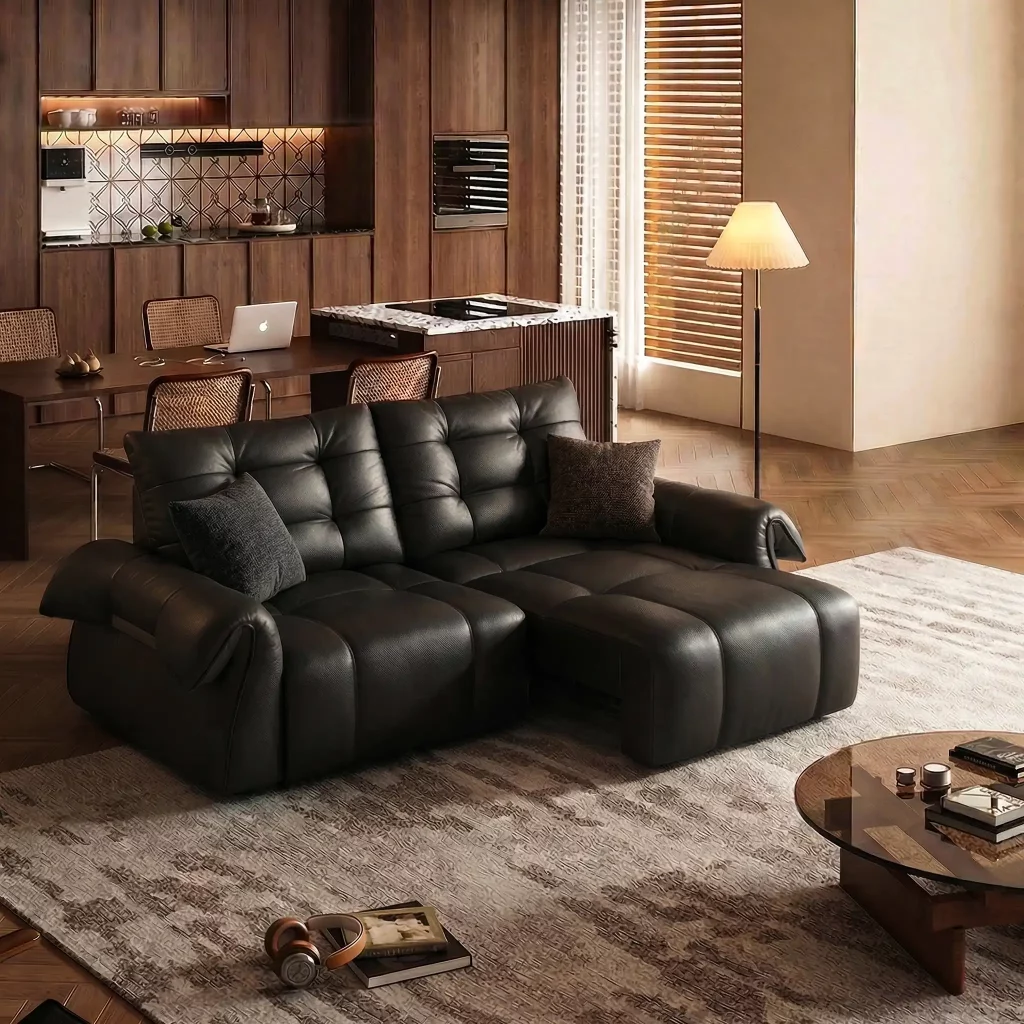 Black leather power sofa bed extended in a modern apartment living room.