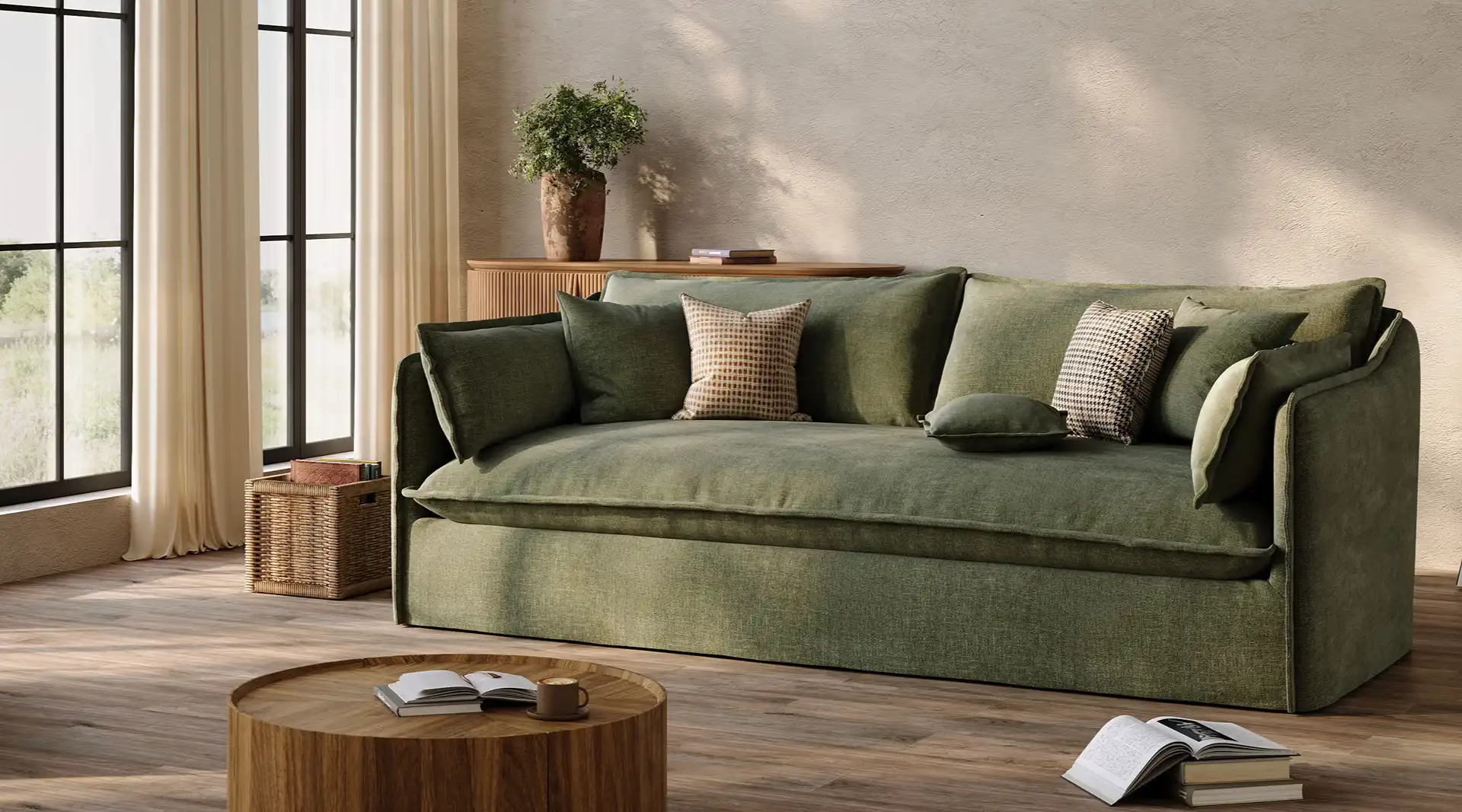 Green upholstered sofa with loose cushions in a sunlit living room with wood furniture and neutral decor.