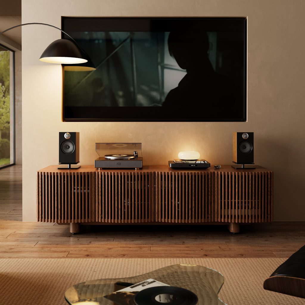 Slatted wood media console with speakers, turntable, and AV equipment beneath a wall-mounted TV.