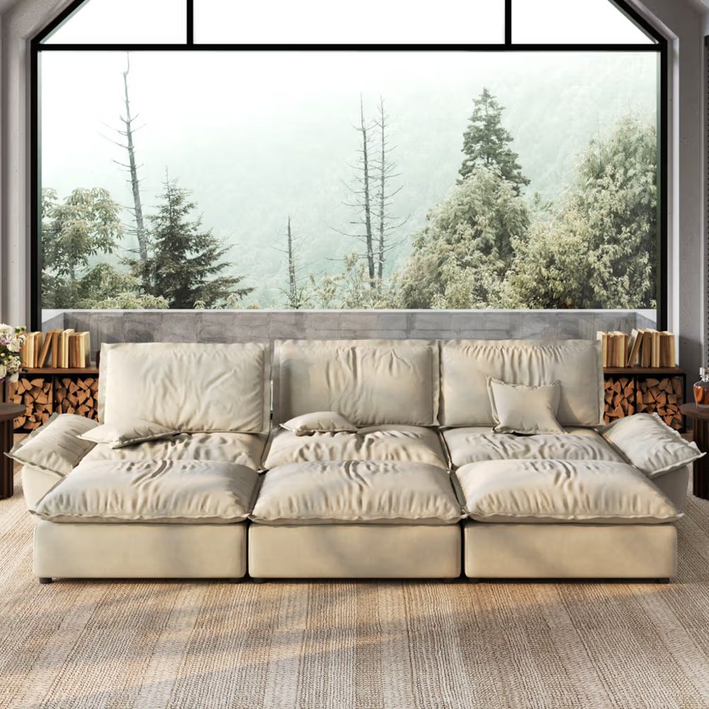 Oversized beige deep-seat sofa with plush cushions in a bright modern living room.