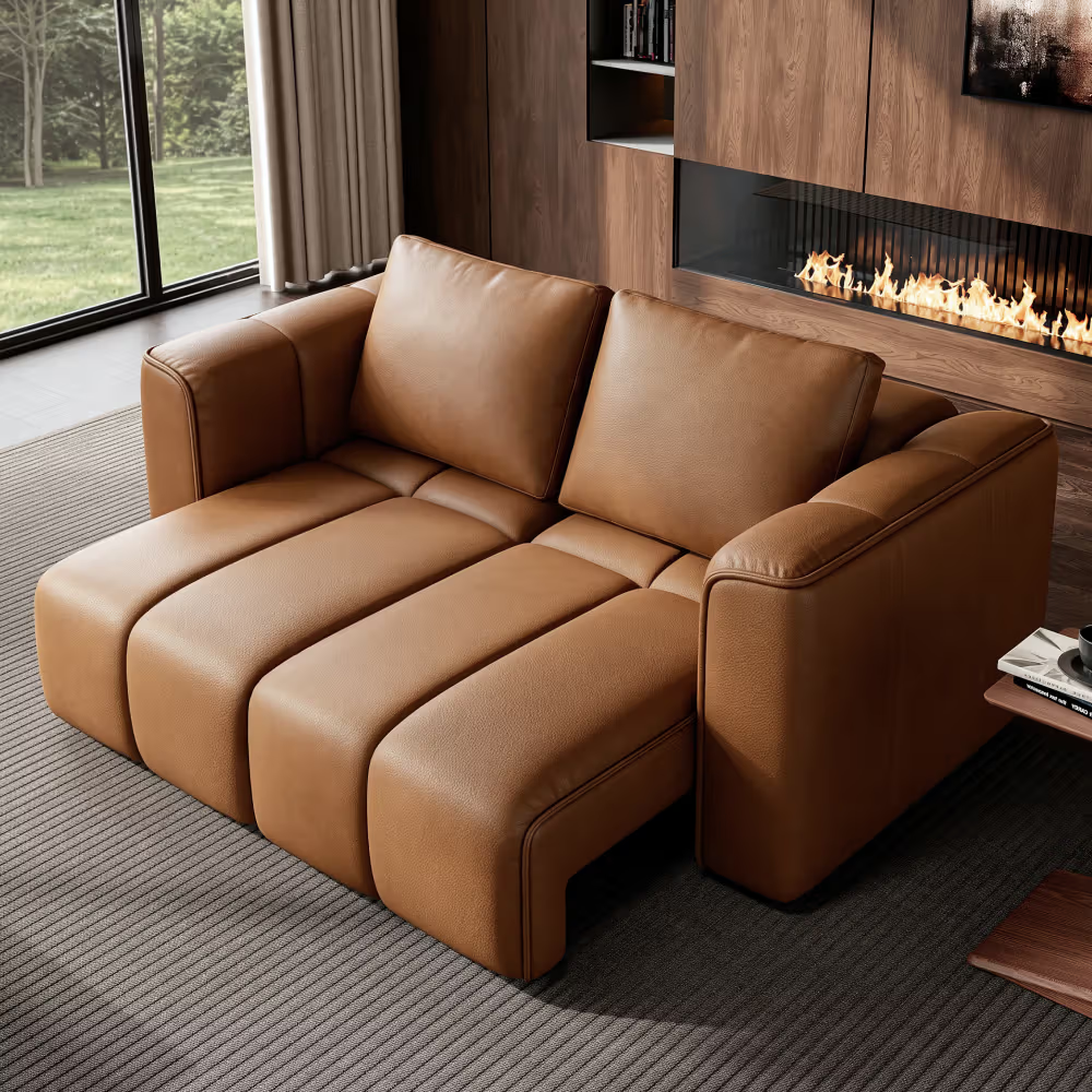 Brown high-arm reclining sofa with extended footrests in a modern living room with a fireplace.