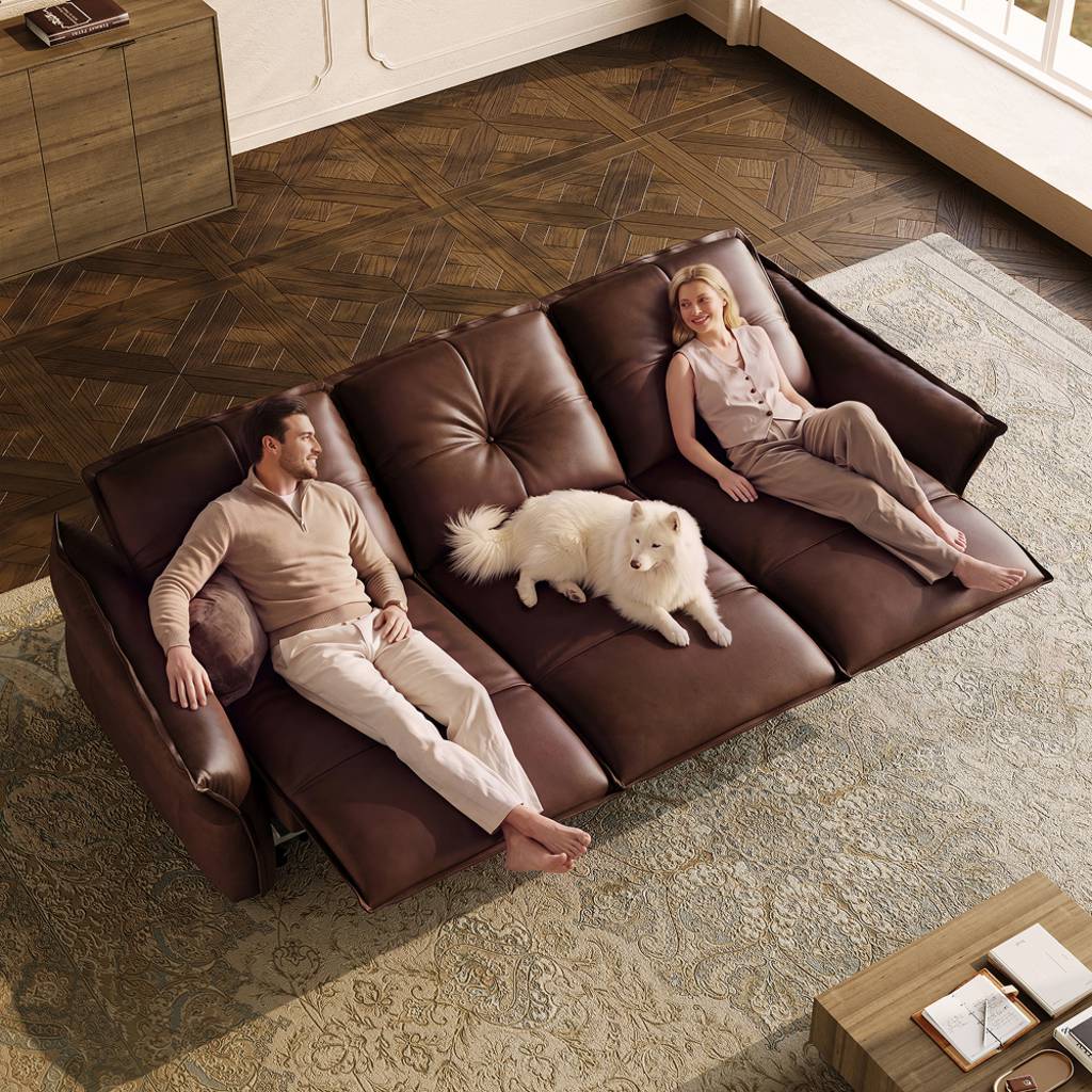 Couple relaxing with a dog on a brown leather reclining sofa with adjustable headrests in a modern living room.