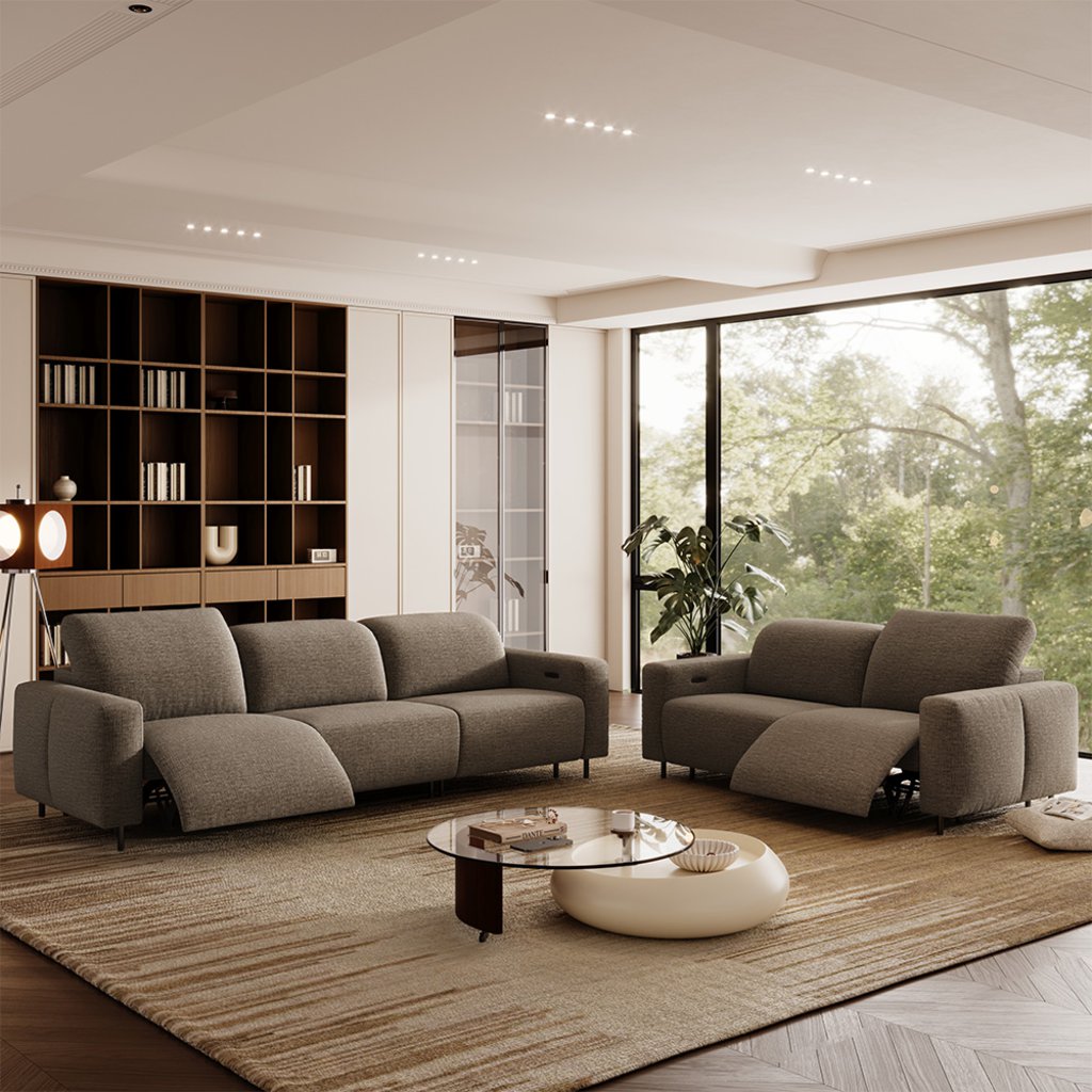 Modern living room with gray power reclining sofas featuring adjustable headrests and extended footrests.