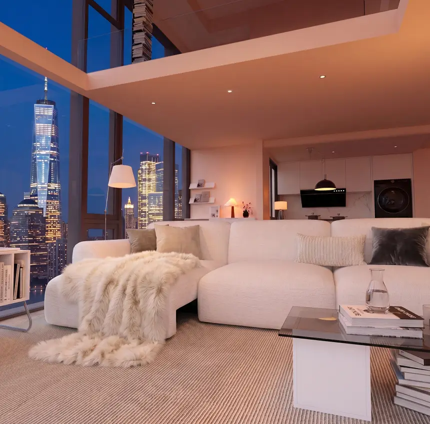 White sofa bed in a high-rise living room overlooking the city at night