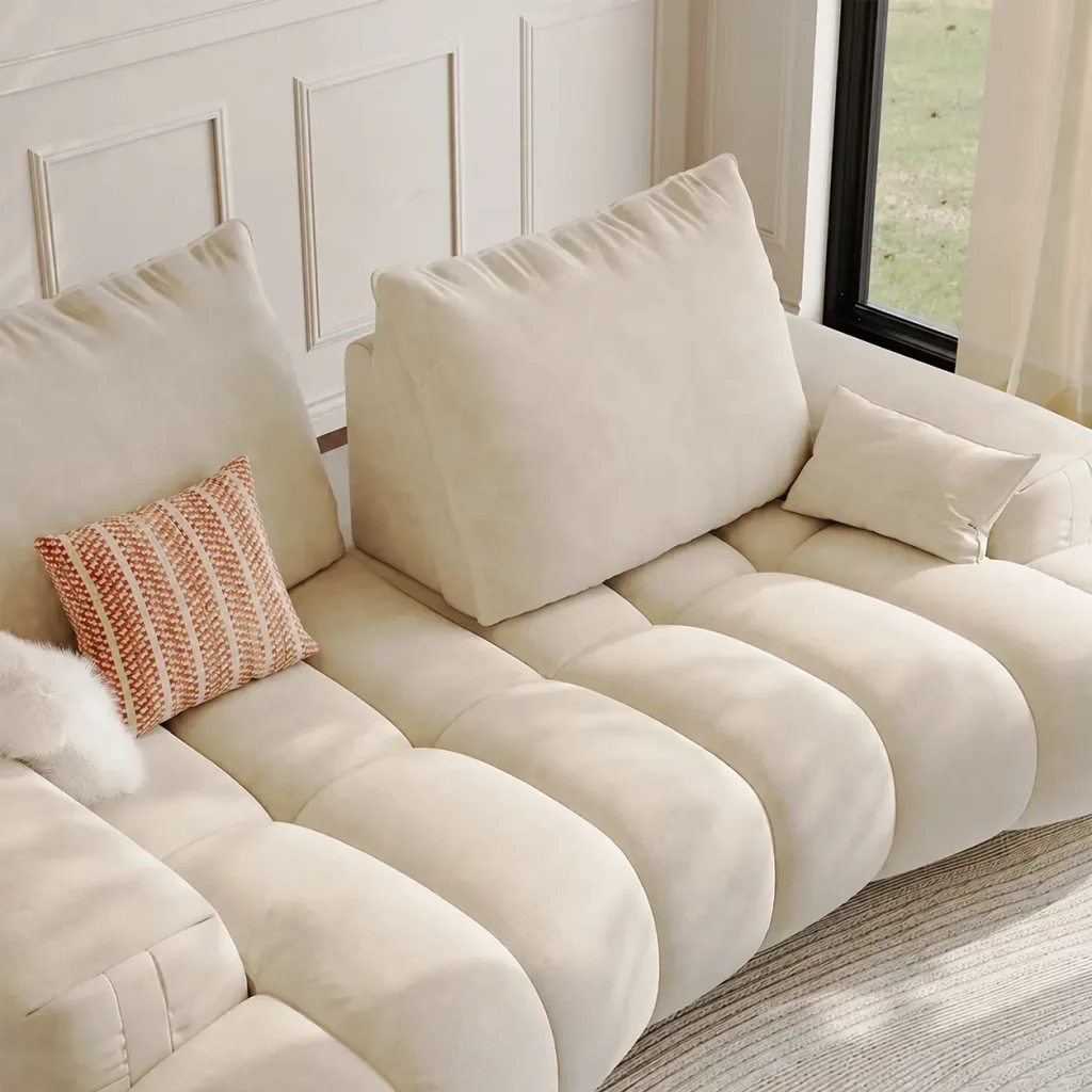 Cream deep-seat sofa with oversized back cushions and throw pillows in a bright living room