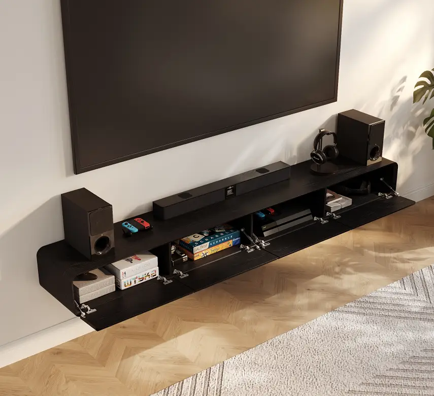 Wall-mounted TV above a floating black TV stand with open media storage, soundbar, speakers, headphones, and game accessories.
