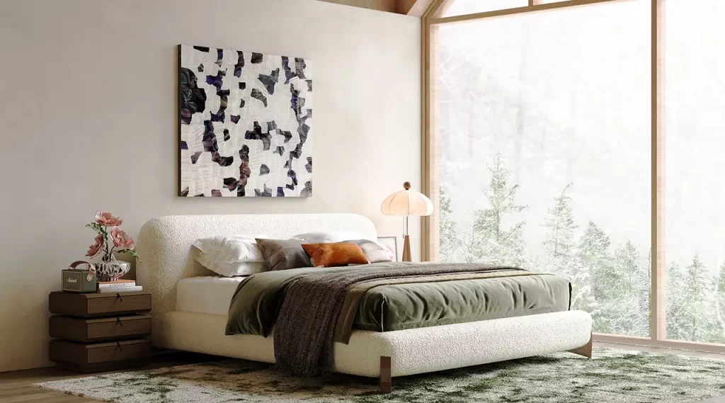 White upholstered bed with layered bedding beside a floor-to-ceiling window