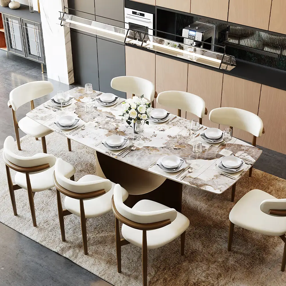 Modern extendable dining table set for eight with white upholstered chairs in an open kitchen and dining space.
