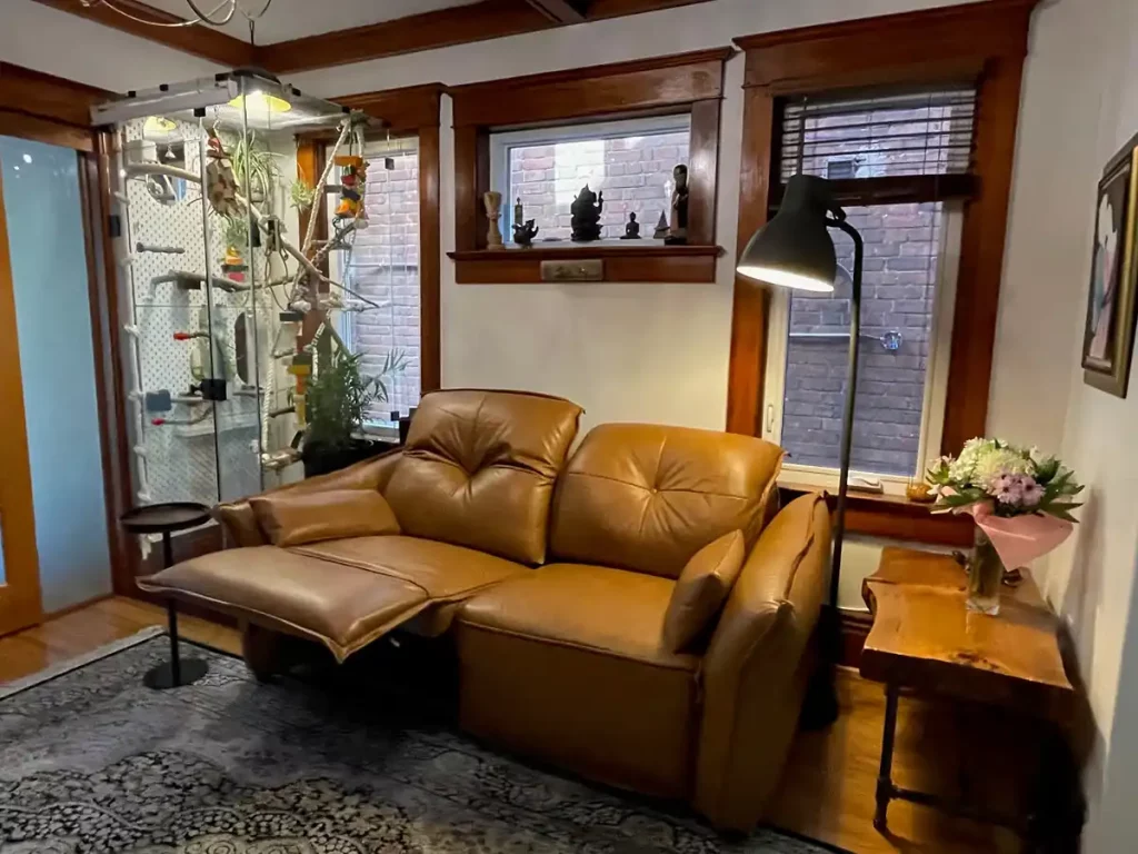 Brown leather reclining sofa with an extended footrest for relaxed everyday seating
