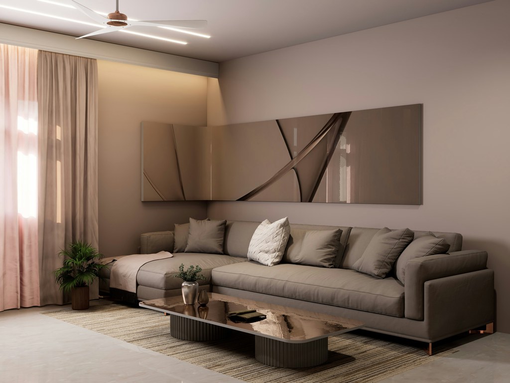 Gray low-arm sectional sofa with chaise and layered cushions in a warm contemporary living room.