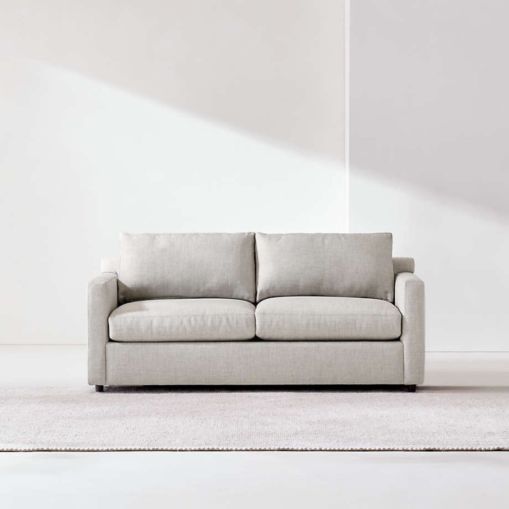 Light gray sleeper sofa with supportive seat and back cushions in a bright minimalist room.