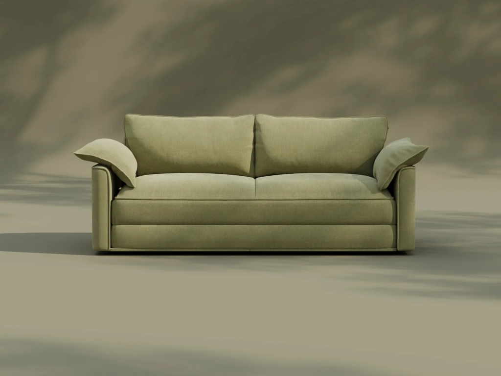 Light green fabric sleeper sofa with two back cushions and matching arm pillows against a neutral studio background.