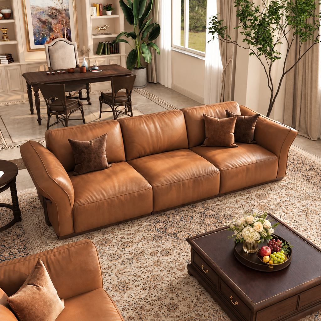 Brown leather sofa with olive green plants, warm white walls, dark wood furniture, and a patterned rug in an earthy living room.