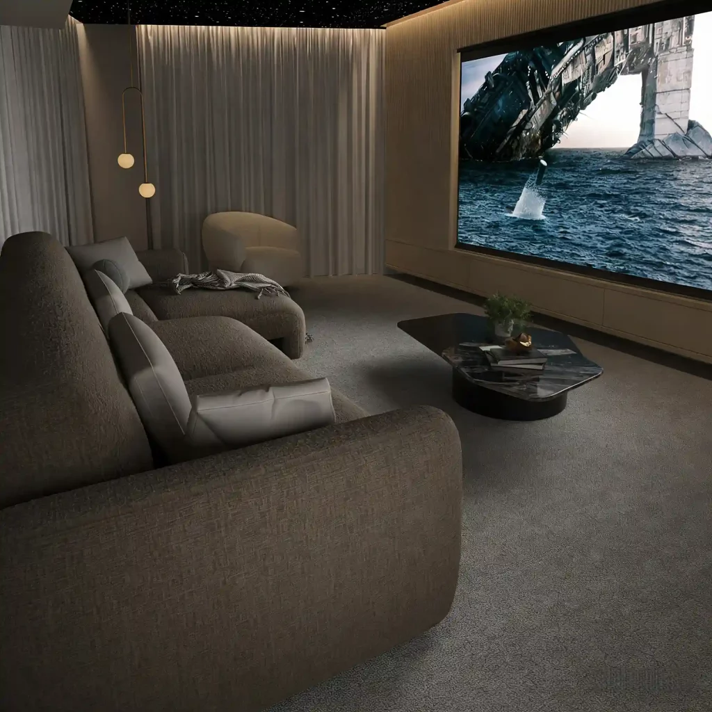 Modern home theater with dark upholstered sofas facing a large screen, a marble coffee table, and warm ambient lighting.