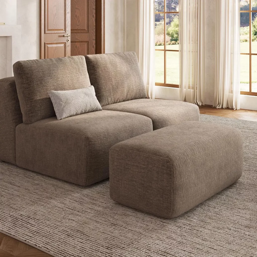 Dark khaki modular sofa with a movable ottoman in a sunlit living room