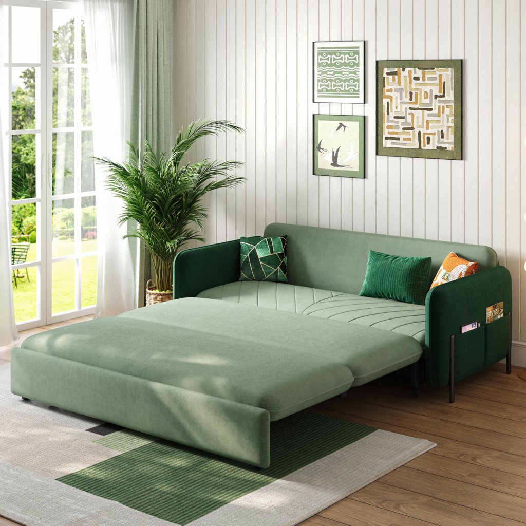 Green velvet three-seater sofa bed fully extended into a sleeping surface, featuring decorative pillows and side storage pockets in a bright living room.