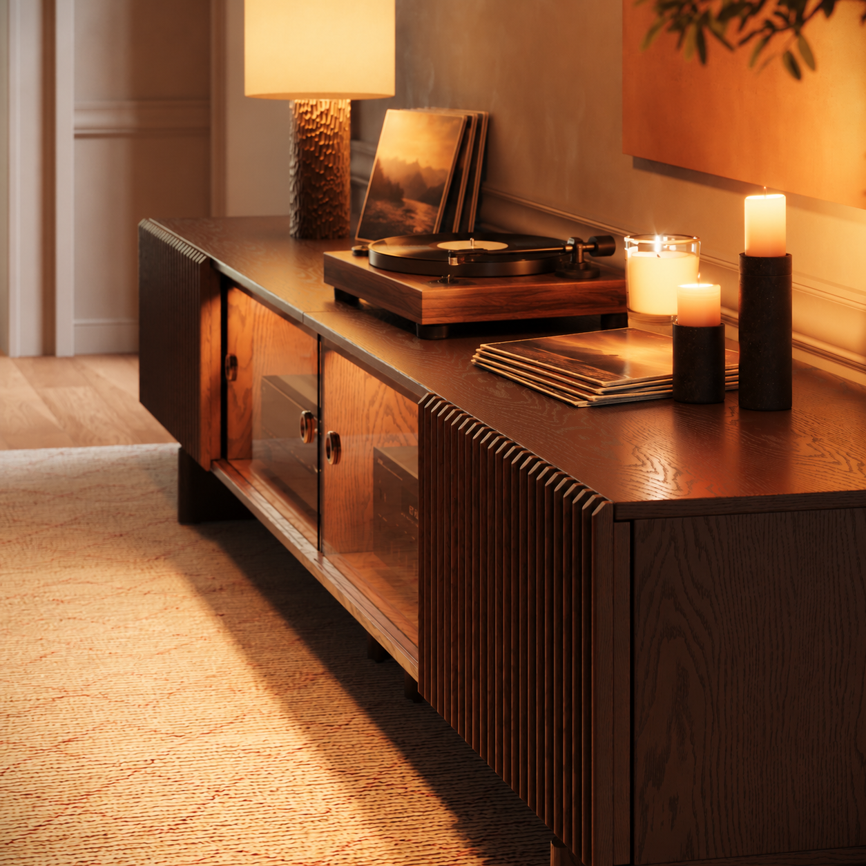 Dark walnut media console styled with a wooden turntable, vinyl records, candles, and a table lamp in a warm, vintage-inspired music room.