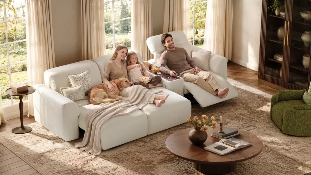 Family relaxing with their dog on a white modular sofa bed with extended seats and adjustable headrests in a bright, modern living room.