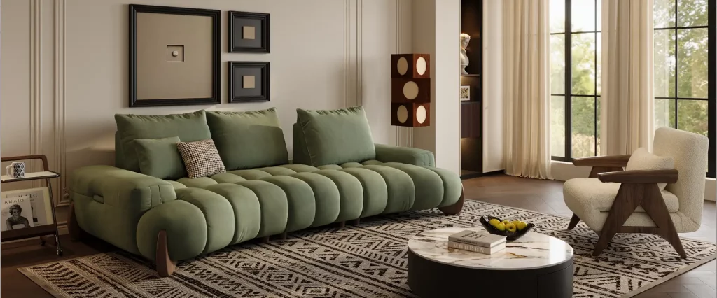 Green deep sofa in a contemporary living room with decorative pillows, patterned rug, coffee table, and accent chair.