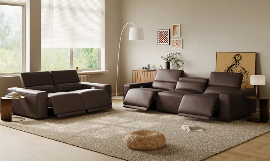 Dark performance leather power reclining sofas with adjustable headrests and extended footrests in a modern living room with a large area rug.