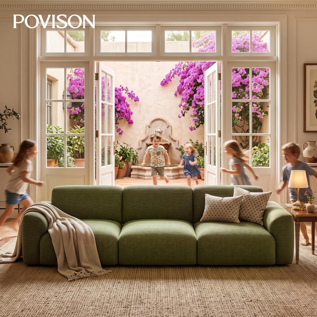 Green modular sofa with throw pillows in a bright living room as children run toward a flower-filled courtyard through open French doors.